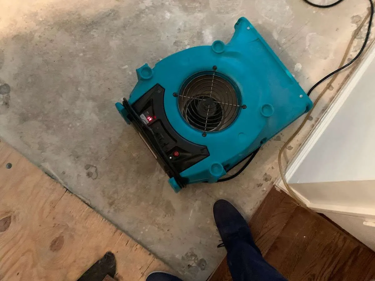 Air mover drying subfloor during Commercial Water Damage Restoration in Clover